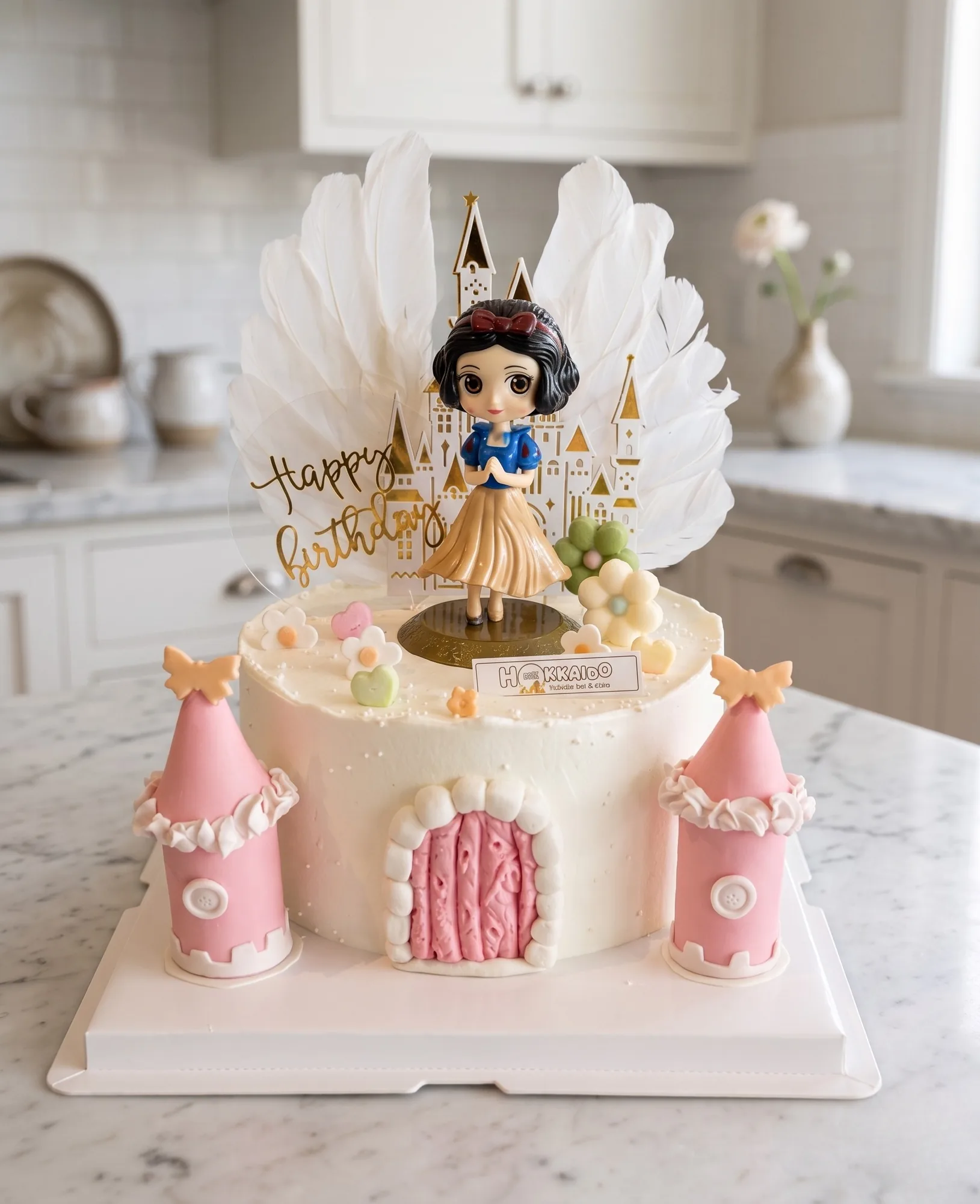 Snow White princess castle cake with feather topper, gold Happy Birthday, and pink fondant towers